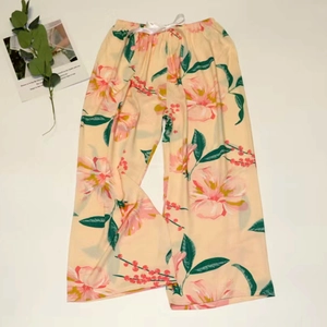 Detail of floral wide-leg pajama pants with elastic waistband and decorative bow tie