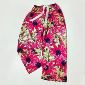 Close-up of lightweight floral pajama pants with elastic drawstring waist and wide legs