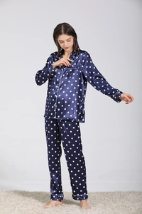 Détail du pyjama en soie bleu marine à pois avec finition satinée et liseré blanc élégant