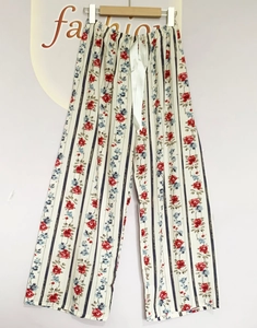 Detail of floral sleep pants with drawstring waist and vertical stripes pattern
