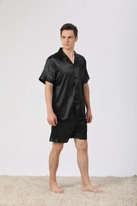 Detail of men's black silk satin pajama set featuring short sleeve shirt and matching shorts