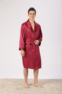 Detailed shot of burgundy silk robe featuring a checkerboard pattern and white piping