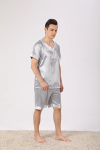 Close-up of men's silk-like pajama set featuring geometric patterns and V-neck design