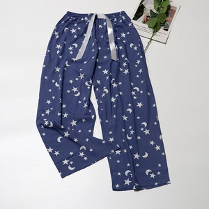 Detail of navy pajama pants with star and moon prints and grey silk drawstring