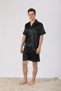 Close-up of men's black satin pajama set showing the silky texture and notched lapel detail