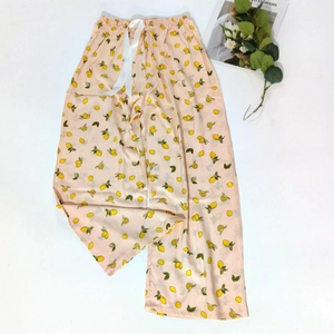 Detail of light pink pajama pants with lemon print and white silk waist drawstring
