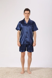 Detail of dark blue satin men's pajama set featuring notch collar and single chest pocket