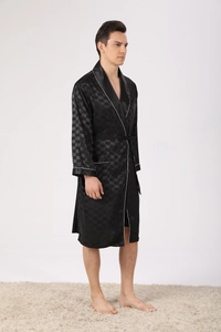 Detail of black silk robe showing glossy checkered texture and white contrast piping