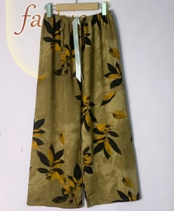 Detail of elastic waist and light blue drawstring on olive green floral lounge pants