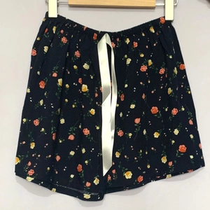 Nahaufnahme der marineblauen Blumen-Shorts mit elastischem Bund und weißer Satinschleife
