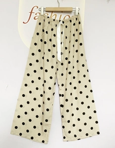 Close-up of lightweight polka dot pajama pants with elastic waist and drawstring detail