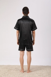 Rear view of men's black ice silk pajama set with white piping and short sleeves