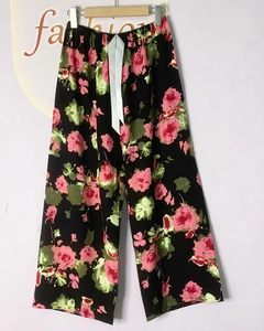 Detail view of floral wide-leg sleep pants with elastic waist and satin ribbon bow
