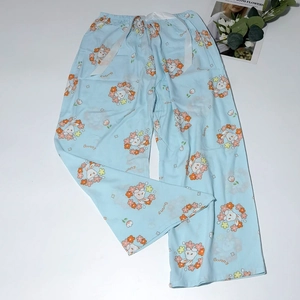 Detailed view of light blue pajama pants with floral bunny prints and drawstring waist