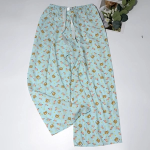 Close-up of light blue floral pajamas with cute bear prints and white satin drawstring