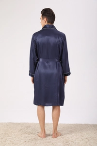 Detail of navy blue silk satin robe featuring vertical stripes and white piping trim