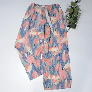 Detail of mint green sleep pants with elastic waist, ribbon tie, and tulip rabbit print