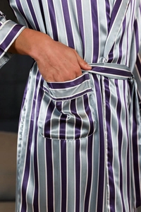 Close-up of men's striped silk bathrobe showing satin fabric texture and waist tie