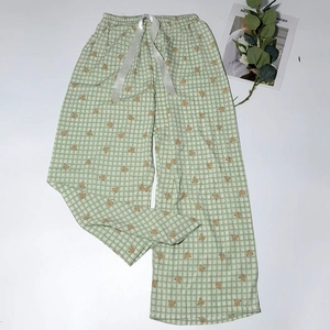 Detail of light green gingham pajama pants with cute bear prints and a satin ribbon bow