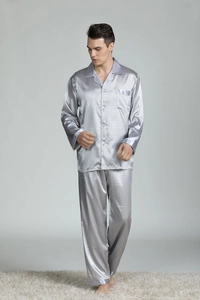 Detail of silver silk men's pajamas featuring lapel collar, pocket and geometric pattern