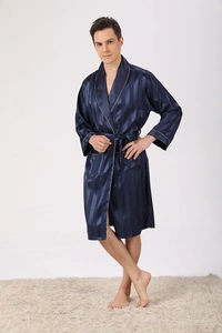 Detail of navy blue silk pajama robe showing vertical stripes and classic white piping