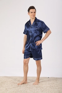Close-up of men's dark blue satin pajamas featuring contrast white piping and chest pocket