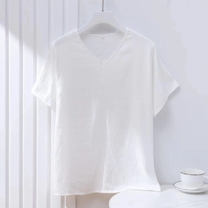 Detail of white V-neck cotton t-shirt with textured fabric and L size label tag