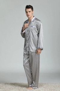 Detail of men's silk pajama set showing grey geometric print and satin piped edges