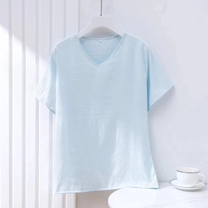 Detail of light blue cotton short-sleeve V-neck t-shirt showing fabric texture and L size tag