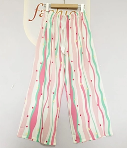 Detail view of elastic waistband with white ribbon bow on striped cotton lounge pants