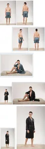 Detail of men's satin silk pajama set featuring robe and shorts with striped texture