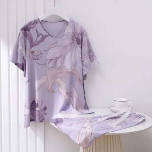 Detail view of purple floral cotton pajamas set with V-neck top and drawstring shorts