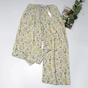 Detail of floral print pajama pants featuring a wide elastic waistband and silk drawstring