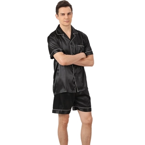 Men's black satin pajama set with short sleeves, shorts, and white piping detail