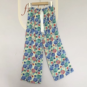 Detail of colorful lollipop print pajama pants with white decorative silk bow at the waist