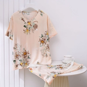 Detail of floral V-neck top and matching drawstring shorts in soft peach silk fabric