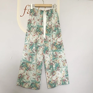 Detail of floral wide-leg sleep pants with elastic waist and white satin drawstring