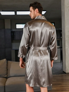 Detail view of silver silk robe back showing contrast white piping and glossy fabric
