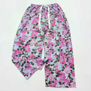 Close-up of floral print pajamas pants with elastic waistband and decorative drawstring
