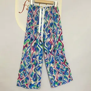 Detail of colorful abstract print wide leg pajama pants with elastic drawstring waist