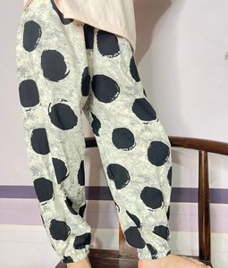 Detail view of children's cotton anti-mosquito pants with black polka dots and elastic cuffs