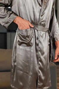 Close-up of men's dark grey silk robe showing white piping detail and functional side pocket