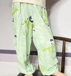 Detail of light green mosquito pants with panda prints and elasticized leg cuffs
