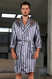 Close-up of smooth purple striped satin bathrobe fabric with pockets and tie belt