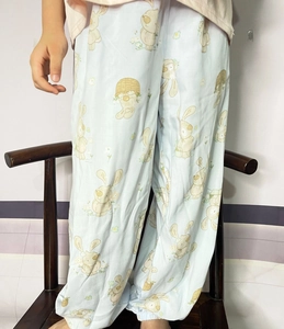 Detail of light blue kids' mosquito pants with rabbit prints and elastic ankle cuffs