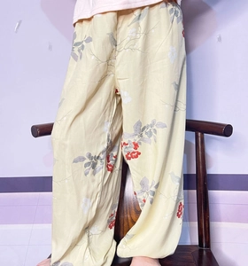Detail of thin cotton anti-mosquito trousers for kids with bird and flower print