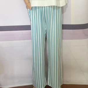 Detail shot of blue and white vertical striped wide-leg trousers with side pockets