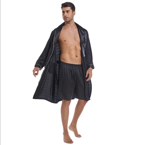 Men's black satin pajama set with contrast white piping detail on sleeves and robe collar
