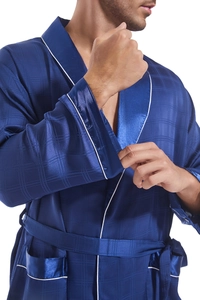 Detail of navy silk bathrobe showing check texture, white piping, and belt material