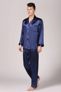 Detail of navy blue satin pajama set for men featuring contrast white piping on the pocket